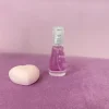 بطری 15 میل عطر ویکتوریا سکرت بامبشل | Victoria's Secret Bombshell اسمارت با طراحی صورتی مینیاتوری در پس‌زمینه‌ای مینیمال.